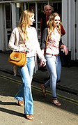Two women wearing flared trousers, jeggings and oversized cardigans