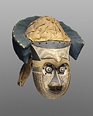 Pwoom Itok mask; late 19th century; 39.1 x 28.6 x 29.8 cm (153⁄8 x 111⁄4 x 113⁄4 in.); Brooklyn Museum (USA). This mask may have represented a wise older man at boys' initiations. One of the principal Kuba dance masks is called pwoom itok. The chief identifying characteristic is the shape of the eyes, whose centers are cones surrounded by holes through which the wearer sees