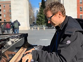 Huggins playing piano in Washington Square Park in January 2019