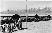 Memorial Day services at Manzanar Camp in 1942 with Boy Scouts performing the flag ceremony