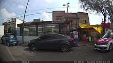 Image of a station entrance behind a car.