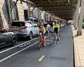 A two-way separated bike lane in Washington, D.C. with parked cars acting as a barrier between bicyclists and traffic