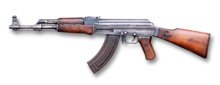 AK-47 assault rifle with curved magazine and wooden stock facing left
