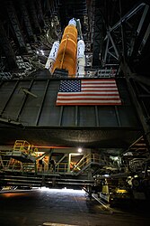 SLS atop the MLP being carried by the CT out of the VAB at Kennedy Space Center in Florida