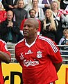 Middle-aged black man wearing a Liverpool football shirt