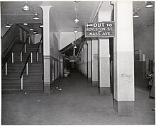 A subway platform with an overhead sign reading "Out to Boylston St. and Mass Ave.