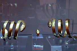 Schlangenarmbänder und Granatring mit eingeschnittener Figur