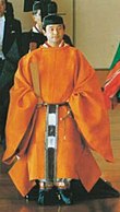 The Crown Prince of Japan wears orange Sokutai.
