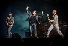 U2 performing on a concert stage.