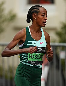 Black woman in a green top running