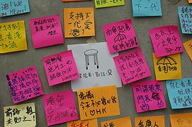 Close-up of post-its on the Lennon Wall