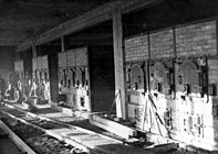 Furnace room in crematorium II, Auschwitz-Birkenau. The picture was taken by the SS before finishing the building in June 1943. Most furnaces and crematoria were supplied by Topf and Sons.