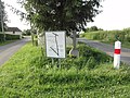 Croix au hameau La Cohue, avec un panneau indicateur de plusieurs lieux-dits de la commune.