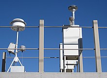 Air pollution monitoring station in Reno, Nevada showing air inlets and sensor.