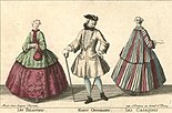 A fashion plate of three individuals, two white women modeling the casaquin: one green casaquin over a maroon dress with a wide crinoline and the second a maroon and green striped one over a matching dress. The casaquin is a coat that falls somewhere between the hips and knees and is wide enough around the skirt of the coat to lay over a wide-hooped skirt. The sleeves of these particular examples are wide and three-fourths length. It's fitted around the bodice. There is a white man in the middle with a tricorn hat, an ivory jacket that reaches his knees with a flared skirt. It has loose sleeves with wide cuffs, and the coat is worn over white stockings and black boots. He has a walking stick in his hand.