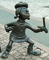 Image 65Statue of Minnie the Minx, a character from The Beano. Launched in 1938, the comic is known for its anarchic humour, with Dennis the Menace appearing on the cover. (from Children's literature)