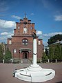 A memorial to the victims of political repressions and the Exaltation of the Holy Cross Church.