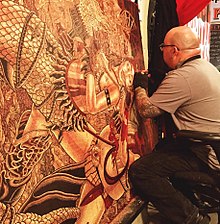 Printmaker Tom Huck at work on a block in the studio