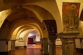 Interior of the Romanesque crypt, with frescos of religious figures visible