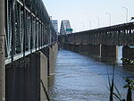 A view of a twinned steel truss bridge, from between the spans.