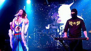 Avidan (left) and Wecht performing in 2019, with TWRP drummer Havve Hogan in the background