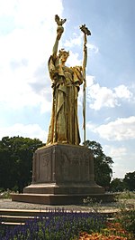 Golden statue of a woman holding a scepter and a dove