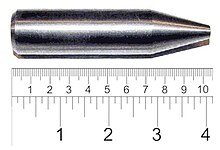 Shiny metallic cylinder with a sharpened tip. The overall length is 9 cm and diameter about 2 cm.