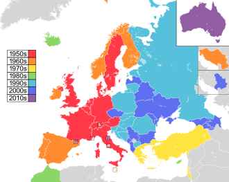Map of countries in Europe, North Africa and Western Asia, with Australia as an insert in the top-right corner, coloured to indicate the decade in which they first participated in the contest: 1950s in red, 1960s in orange, 1970s in yellow, 1980s in green; 1990s in sky blue; 2000s in blue; and 2010s in purple