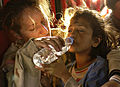 Image 32A young girl drinking bottled water (from Water)