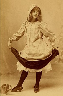 Young woman posing holding a sash and wearing a bonnet