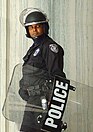 Police officer with riot shield