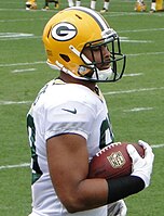 Richard Rodgers in uniform holding a football