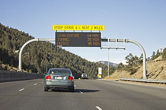 A full matrix walk-in cabinet LED sign (manufactured by Skyline Products) displaying travel times on Interstate 70 north of Evergreen, Colorado, USA.