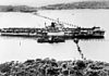 An aircraft carrier passing through the anti-submarine boom net in Sydney Harbour in 1945.