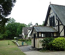 Gabled building with a railway platform behind it.