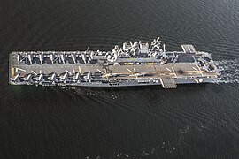 USS Tripoli (LHA-7), an America-class amphibious assault ship in light aircraft carrier mode with two squadrons of F-35B fighters aboard