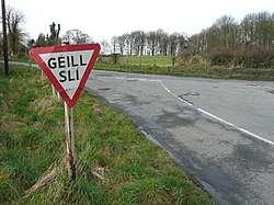 Irish-language road sign on a road junction in Baile Ghib