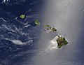 Sunglint highlights calmer conditions in the lee of the Hawaiian islands.