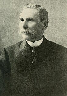 Sepia-toned 1906 head and shoulders photo of James H. Blessing, facing front, looking to his right