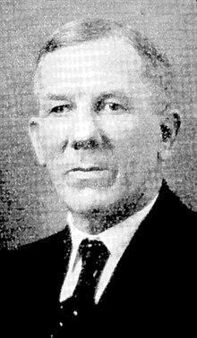 Black and white portrait of a man wearing a suit and tie