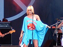 Robyn onstage in an off-the-shoulder blue outfit