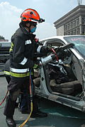 A firefighter using a hydraulic cutter during a demonstration