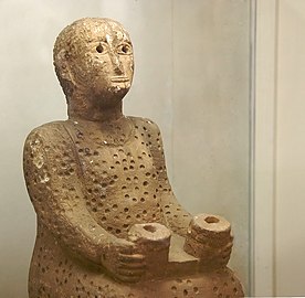 Stone statue from Addi-Galamo, Tigray Region (dated 6th-5th century BCE), part of the National Museum's collection. The statue is inscribed with a phrase in South Arabian, "For God Grants a Child to Yamanat".