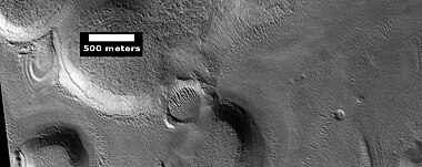 Mantle layers, as seen by HiRISE under HiWish program. Mantle layers seem to be forming a group of dipping layers.