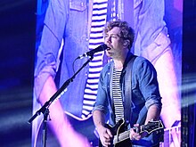 Bourne performing with Busted at Manchester Arena, 2016