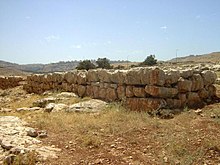 Colored photograph showing a rectangular stone structure