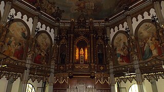 Statue of the Holy Infant of Prague enshrined in the cedar wood retablo