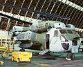 A USMC CH-53D "Sea Stallion" helicopter undergoes maintenance inside one of MCAS Tustin's giant blimp hangars, date unknown.