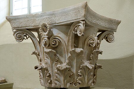 Ancient Greek Corinthian capital with a fleuron on the abacus, from the tholos at Epidaurus, said to have been designed by Polyclitus the Younger, c.350 BC, stone, Archaeological Museum of Epidaurus, Greece[3]