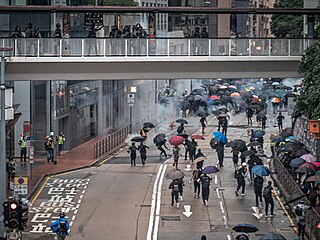 Police disperse crowd with tear gas.